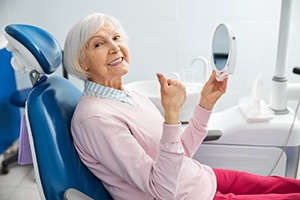 Senior dental patient making thumbs-up gesture