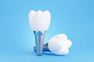 Two dental implants and crowns against blue background