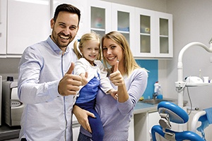 Happy family standing in dentist’s office