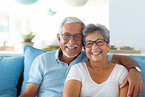 Smiling senior couple sitting on sofa