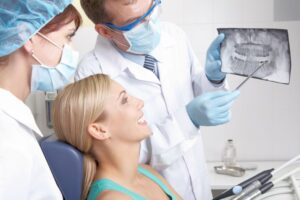 Dentist and patient reviewing X-ray together